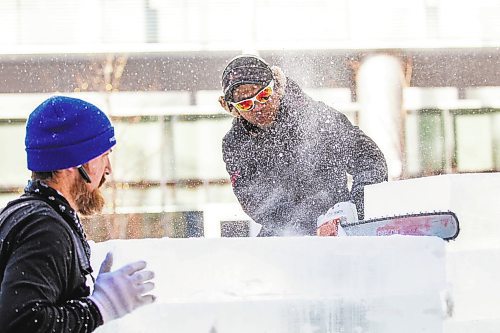 MIKAELA MACKENZIE / WINNIPEG FREE PRESS

Victor Dagatan cuts an ice block to fit on the stack as Nate McKeough holds it in place in preparation for ice carving at True North Square in Winnipeg on Tuesday, Feb. 7, 2023. For &#x460;story.

Winnipeg Free Press 2023.