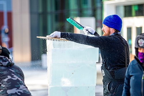 MIKAELA MACKENZIE / WINNIPEG FREE PRESS

Nate McKeough stacks ice blocks in preparation for ice carving at True North Square in Winnipeg on Tuesday, Feb. 7, 2023. For &#x460;story.

Winnipeg Free Press 2023.