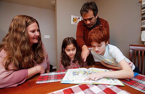 JOHN WOODS / WINNIPEG FREE PRESS
Jane Friesen and Ulises Cancino, who is from Chile, look over some spanish books with their children Noa, 6, and Ian, 10, in their home Tuesday, February 7, 2023. The Winnipeg School division has extended it&#x573; bilingual Spanish program at Earl Grey School.
 
Re: macintosh