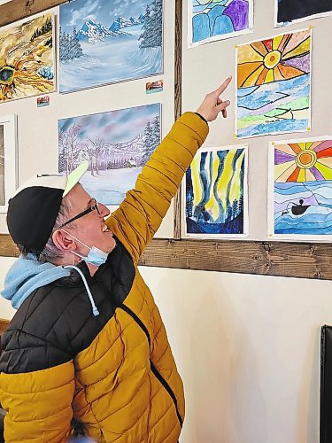 Stanley Szwagierczak points out a painting he created which was on display at the art gallery at Brews Brothers Bistro in Neepawa earlier this month. (Miranda Leybourne/The Brandon Sun)