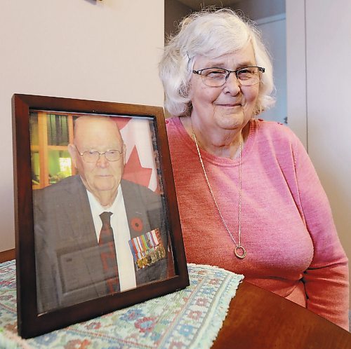 Faye Carkener is shown here with a photograph of her father Arthur Ross Neale, one of the founders of the 26th Field Regiment RCA/XII Manitoba Dragoons Museum. Carkener is a volunteer at the museum her father helped establish. (Ian Hitchen/Brandon Sun)