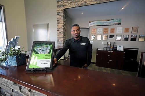 Ephreim Tamene shows off the award of merit Alternative Group won from the Manitoba Nursery Landscape Association for a woodland retreat design he worked on. (Colin Slark/The Brandon Sun)