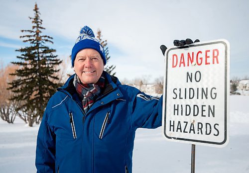 Mike Sudoma/Winnipeg Free Press
Community member Wesley Wold stands next to a sign warning folks of all ages from sliding down a hill next to Whyte Ridge Elementary School because of &#x201c;Hidden Hazards&#x201d;
February 10, 2023 