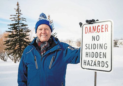 Mike Sudoma/Winnipeg Free Press
Community member Wesley Wold stands next to a sign warning folks of all ages from sliding down a hill next to Whyte Ridge Elementary School because of &#x201c;Hidden Hazards&#x201d;
February 10, 2023 