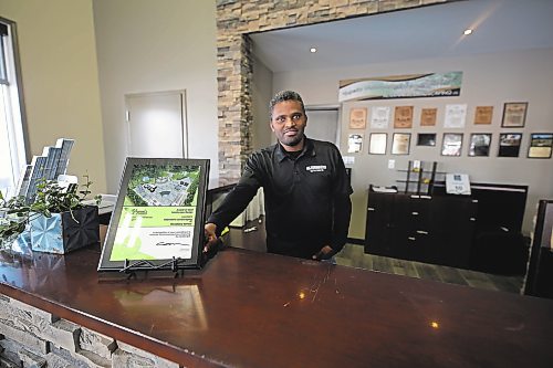 Ephreim Tamene shows off the award of merit Alternative Group won from the Manitoba Nursery Landscape Association for a woodland retreat design he worked on. (Colin Slark/The Brandon Sun)