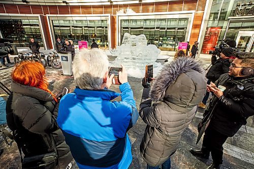 MIKE DEAL / WINNIPEG FREE PRESS
Crowds take photos of the ice sculpture that was revealed during the launch of Downtown Winnipeg BIZ's Winter Wanderland Friday morning in True North Square.
230210 - Friday, February 10, 2023.