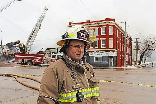 Winnipeg Fire Paramedic Service assistant chief Scott Wilkinson on the scene of a fire in the 800 block of Main Street on Feb. 11, 2023. The fire began inside Surplus Direct at 843 Main Street around 2:00 a.m. before spreading to neighbouring businesses Lord Selkirk Furniture (835 Main Street) and Top Pro Roofing Ltd. (847 Main Street). All three buildings were destroyed. (Tyler Searle / Winnipeg Free Press)