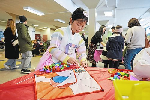 DAVID LIPNOWSKI / WINNIPEG FREE PRESS

Temi Kim (8 years-old) enjoys decorating a traditional Korean Kite during K-Culture Festival at Grant Park High School Saturday February 11, 2023.