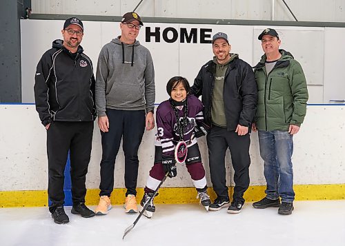 DAVID LIPNOWSKI / WINNIPEG FREE PRESS


(Left to right) Assistant head coach Mitch Rowson, head coach Christian Taylor, Finn Batoon, assistant coach Jeff Correia, and manager Roger Pockett photographed at the Seven Oaks Arena  Saturday February 11, 2023.
Finn moved to Canada from The Philippines in 2019, and the 11-year-old has become so adept at the sport that he now part of the U13 Raiders team after trying out last September.

This Story forms parts of a bigger feature on how a once-alien sport has now become part and parcel of newcomer and immigrant children&#x2019;s lives.
