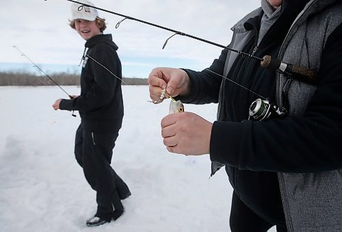 JOHN WOODS / WINNIPEG FREE PRESS
Sherry Urbanski, unhooks a fish as Sean Scott, volunteer, looks on during a workshop on a lake at Fort Whyte Sunday, February 12, 2023. Roselle Turenne, owner of Prairie Gal Fishing, runs fishing workshops for women where she teaches women the ins and outs of ice-fishing.

Re: Sanderson