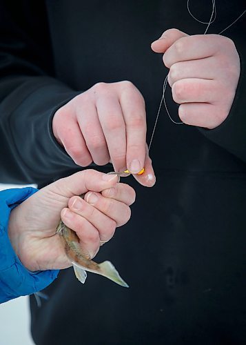 JOHN WOODS / WINNIPEG FREE PRESS
Roselle Turenne, owner of Prairie Gal Fishing, and Sean Scott, volunteer, unhook a fish during a fishing workshop on a lake at Fort Whyte Sunday, February 12, 2023. Turenne runs fishing workshops for women where she teaches women the ins and outs of ice-fishing.

Re: Sanderson