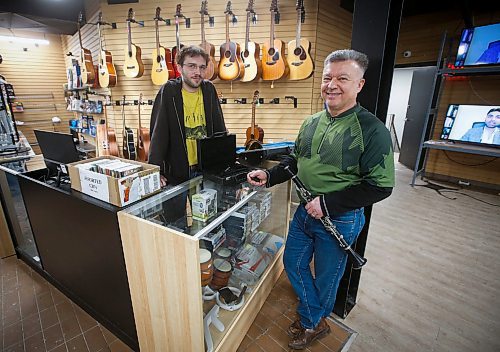 JOHN WOODS / WINNIPEG FREE PRESS
Sean Mychasiw, left, and Ray Bach of the local band Boys Road chat about instruments at the pawn shop where Mychasiw works Monday, February 13, 2023. The pair met when Bach was shopping for a saxophone. Mychasiw invited Bach to play in a gig with them when he heard him test out a saxophone.

Re: Waldman