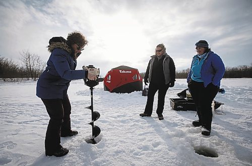 JOHN WOODS / WINNIPEG FREE PRESS
Dana Urbanski drills a hole with an auger as her sister Sherry, centre, and Roselle Turenne, owner of Prairie Gal Fishing, look on during a fishing workshop on a lake at Fort Whyte Sunday, February 12, 2023. Turenne runs fishing workshops for women where she teaches women the ins and outs of ice-fishing.

Re: Sanderson