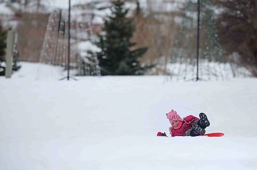 Six-year-old Madison MacDonald from Minto smiles after completing her sled down Hanbury Hill on a windy Tuesday afternoon. (Matt Goerzen/The Brandon Sun)