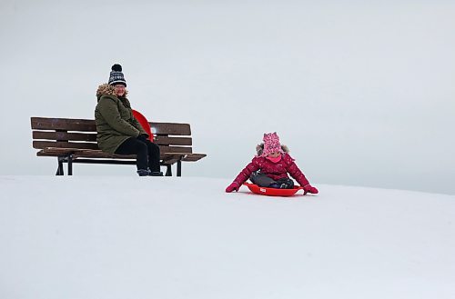 Minto resident Stephanie MacDonald watches her six-year-old daughter Madison MacDonald get read to sled down from the top of Hanbury Hill on a windy Tuesday afternoon in Brandon. (Matt Goerzen/The Brandon Sun)
