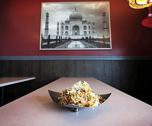 RUTH BONNEVILLE / WINNIPEG FREE PRESS 

ENT - Cilantro's

Dishes photographed: Chicken biryani (rice dish) and Paneer Lababdar (copper container) at Cilantro&#x573; restaurant.

Subject: Photos for a Tasting Notes feature on Cilantro&#x573; a modern fast casual Indian restaurant that has two locations in Winnipeg. Photo of  co-owners Kapil Gusain and Ritesh Patel (chef) with their chicken biryani (rice dish) and paneer lababdar dishes.

Eva Wasney.

Feb 14th,  2023