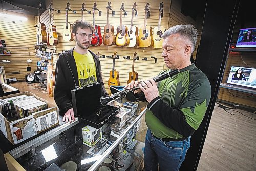 JOHN WOODS / WINNIPEG FREE PRESS
Sean Mychasiw, left, and Ray Bach of the local band Boys Road chat about instruments at the pawn shop where Mychasiw works Monday, February 13, 2023. The pair met when Bach was shopping for a saxophone. Mychasiw invited Bach to play in a gig with them when he heard him test out a saxophone.

Re: Waldman