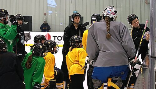 Brandon female under-15 AAA Wheat Kings head coach Karissa Kirkup, right, laughs as she details a drill to her team during a recent practice at J&G Homes Arena. (Perry Bergson/The Brandon Sun)
