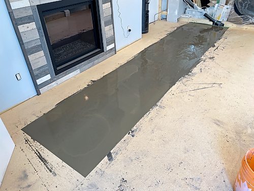 Photos by Marc LaBossiere / Winnipeg Free Press
Self-levelling compound is used to eliminate a hump along one seam of the adjacent plywood subfloor.
 