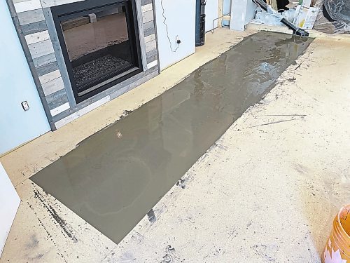 Photos by Marc LaBossiere / Winnipeg Free Press
Self-levelling compound is used to eliminate a hump along one seam of the adjacent plywood subfloor.
 