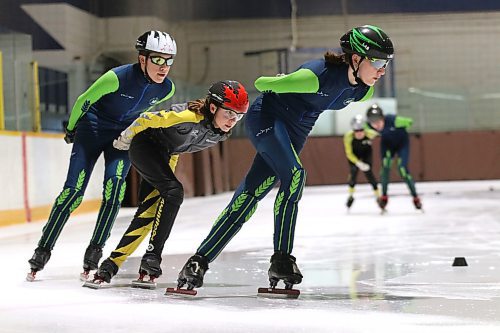 Jada Kasprick, right, leads Westman Speed Skating Club teammates Zoe Forbes (red helmet) and Jackson Chastellaine (white helmet) during a training session at the Sportsplex on Sunday. (Perry Bergson/The Brandon Sun)