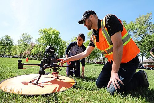 Samm Mohan of Maples Met School learns about the different parts of a drone from Matthew Johnson, education director of Volatus Aerospace, last June. (Winnipeg Free Press)