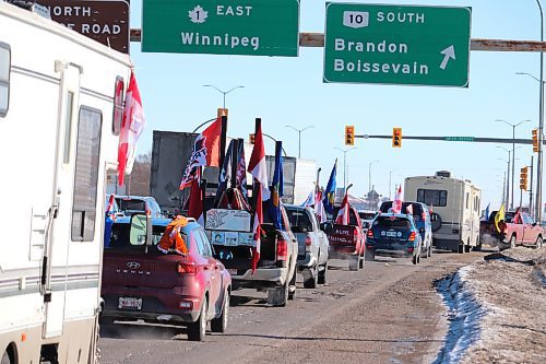 Members of the World Unity Convoy make a pit stop in Brandon Thursday morning on their way to Winnipeg, where they are expecting to gather at a 200-acre site just outside of the city to protest against government corruption. (Kyle Darbyson/The Brandon Sun)