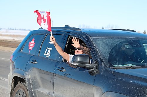 A member of the World Unity Convoy waves to Westman supporters as the group of motorists makes its way into Brandon on Thursday morning. (Kyle Darbyson/The Brandon Sun)