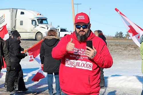 A member of the World Unity Convoy shows off his "Pure Blood" hat and hoodie as the group arrives in Brandon late Thursday morning, proudly showcasing his unvaccinated status to the public. (Kyle Darbyson/The Brandon Sun)