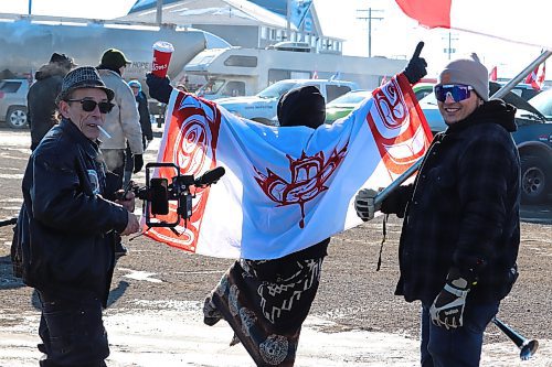Westman residents celebrate the arrival of the World Unity Convoy as they drive into the Husky gas station off of Highway 1 in Brandon on Thursday morning. (Kyle Darbyson/The Brandon Sun) 