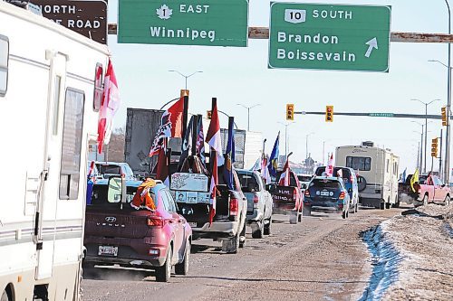 Members of the World Unity Convoy make a pit stop in Brandon on Thursday morning on their way to Winnipeg, where they are expecting to gathering at a 200-acre site just outside of the city to protest against government corruption. (Kyle Darbyson/The Brandon Sun)