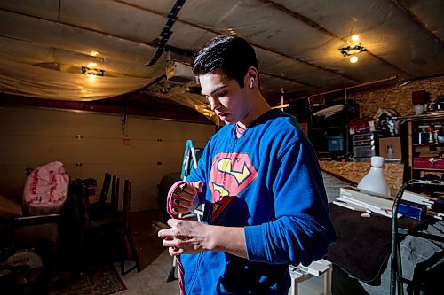 Mike Sudoma/Winnipeg Free Press
Eli Serada warps his hands prior to training inside of his garage boxing gym set up Thursday evening
February 16, 2023 