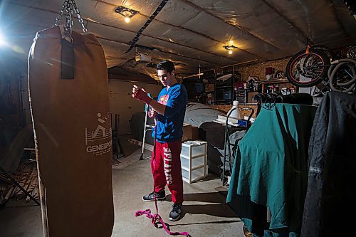 Mike Sudoma/Winnipeg Free Press
Eli Serada warps his hands prior to training inside of his garage boxing gym set up Thursday evening
February 16, 2023 