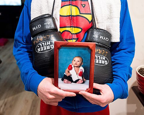 Mike Sudoma/Winnipeg Free Press
Local boxer Eli Serada holds up an image of him as a 7 week year old wearing boxing gloves and a boxing towel around his neck Thursday evening
February 16, 2023 