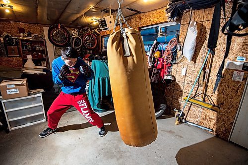 Mike Sudoma/Winnipeg Free Press
Eli Serada trains inside of his garage boxing gym set up Thursday evening
February 16, 2023 