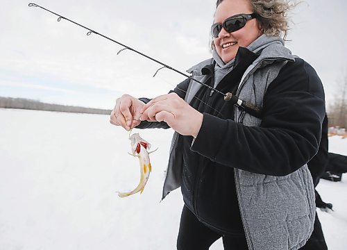 JOHN WOODS / WINNIPEG FREE PRESS
Sherry Urbanski, unhooks a fish during a workshop on a lake at Fort Whyte Sunday, February 12, 2023. Roselle Turenne, owner of Prairie Gal Fishing, runs fishing workshops for women where she teaches women the ins and outs of ice-fishing.

Re: Sanderson