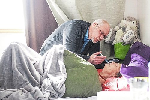 MIKAELA MACKENZIE / WINNIPEG FREE PRESS

Eric De Schepper cares (drips water into her mouth using a syringe) for his common-law wife, Katherine Ellis, who has pancreatic cancer and has opted for palliative care in Winnipeg on Friday, Feb. 17, 2023. He feels the health care system has failed them, as it took him going to the media to get any support in terms of home care workers. For Kevin story.

Winnipeg Free Press 2023.