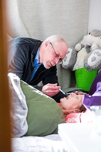 MIKAELA MACKENZIE / WINNIPEG FREE PRESS

Eric De Schepper cares (drips water into her mouth using a syringe) for his common-law wife, Katherine Ellis, who has pancreatic cancer and has opted for palliative care in Winnipeg on Friday, Feb. 17, 2023. He feels the health care system has failed them, as it took him going to the media to get any support in terms of home care workers. For Kevin story.

Winnipeg Free Press 2023.