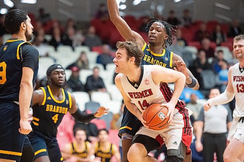 Mike Sudoma/Winnipeg Free Press
Winnipeg Wesmen forward Mikhail Mikhailov lkeeps the ball away from Brandon University Bobcats defence as they play at the Duckworth centre Saturday
February 18, 2023 