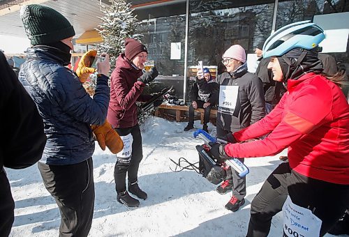 JOHN WOODS / WINNIPEG FREE PRESS
Aggie Gigiel, right, of team Chafing The Dream waits as teammate Kelsey Jones finishes her beer before she can start her leg of the team skate relay race at the Beer Can Olympics outside the Gas Station Theatre in Osborne Village in Winnipeg, Sunday, February 19, 2023. 

Re: ?