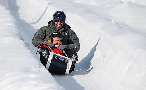 JOHN WOODS / WINNIPEG FREE PRESS
Andrew Cyr and son Leif slide down a toboggan run at the Festival du Voyageur in Winnipeg, Sunday, February 19, 2023. 

Re: pindera
