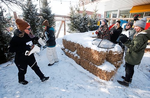 JOHN WOODS / WINNIPEG FREE PRESS
Members of team Big Cat Energy cheer on their athletes as they start the next leg of the skate relay race at the Beer Can Olympics outside the Gas Station Theatre in Osborne Village in Winnipeg, Sunday, February 19, 2023. 

Re: ?