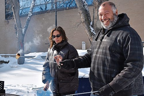 Daija Bird and her father enjoyed cooking Bannock over an open fire during the Louis Riel Day event at Brandon University on Monday. (Geena Mortfield/The Brandon Sun)