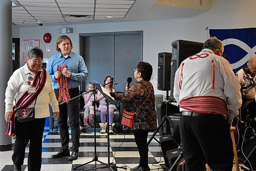 Mayor Jeff Fawcett (second from left) speaks during the opening remarks at the Louis Riel Day festivities at Brandon University on Monday. (Geena Mortfield/The Brandon Sun)