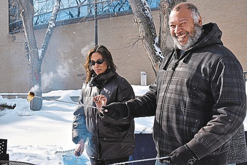 Daija Bird and her father enjoyed cooking Bannock over an open fire during the Louis Riel Day event at Brandon University. (The Brandon Sun/Geena Mortfield)