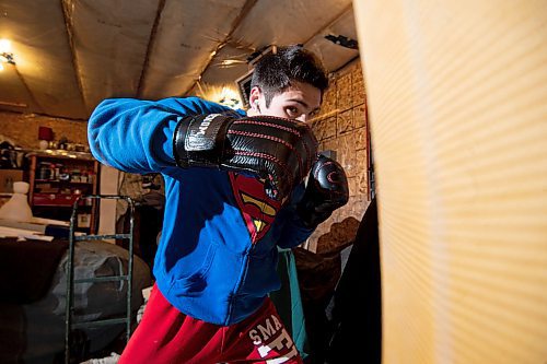 Mike Sudoma/Winnipeg Free Press
Eli Serada trains inside of his garage boxing gym set up Thursday evening
February 16, 2023 