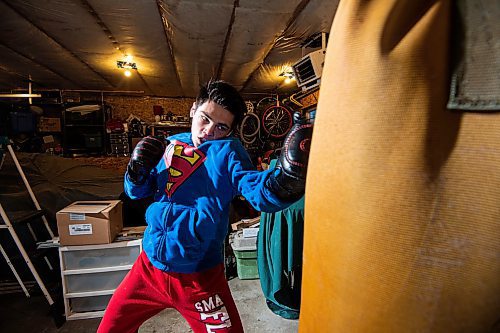 Mike Sudoma/Winnipeg Free Press
Eli Serada trains inside of his garage boxing gym set up Thursday evening
February 16, 2023 