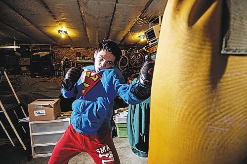 Mike Sudoma/Winnipeg Free Press
Eli Serada trains inside of his garage boxing gym set up Thursday evening
February 16, 2023 