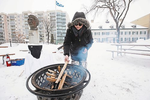 JOHN WOODS / WINNIPEG FREE PRESS
Kyra De La Ronde puts wood on the fire at the Louis Riel Day celebration at the Saint Boniface Museum in Winnipeg, Monday, February 20, 2023.

Reporter: Pindera