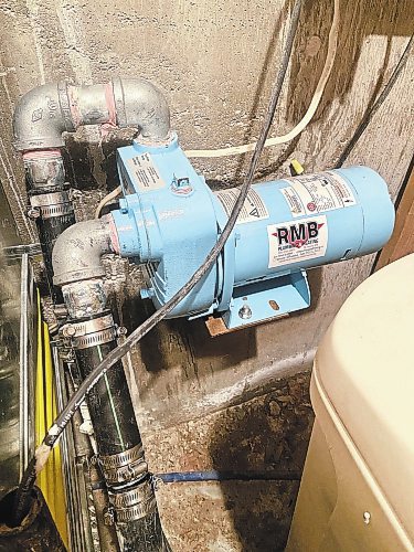 Photos by Marc LaBossiere / Winnipeg Free Press
The new half—horsepower septic pump was mounted on the old bracket, attached to new fittings for the in and out-flow of the septic system.
 